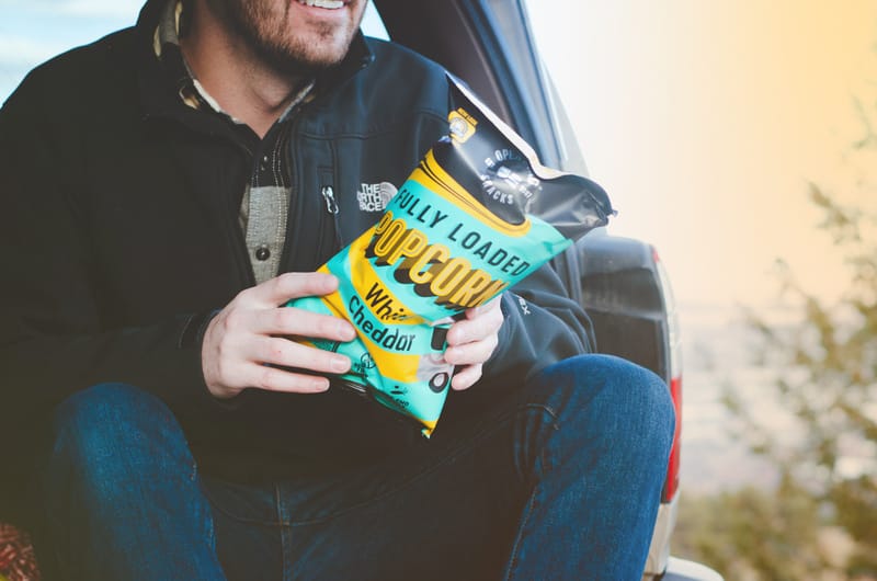 Man sitting with popcorn bag